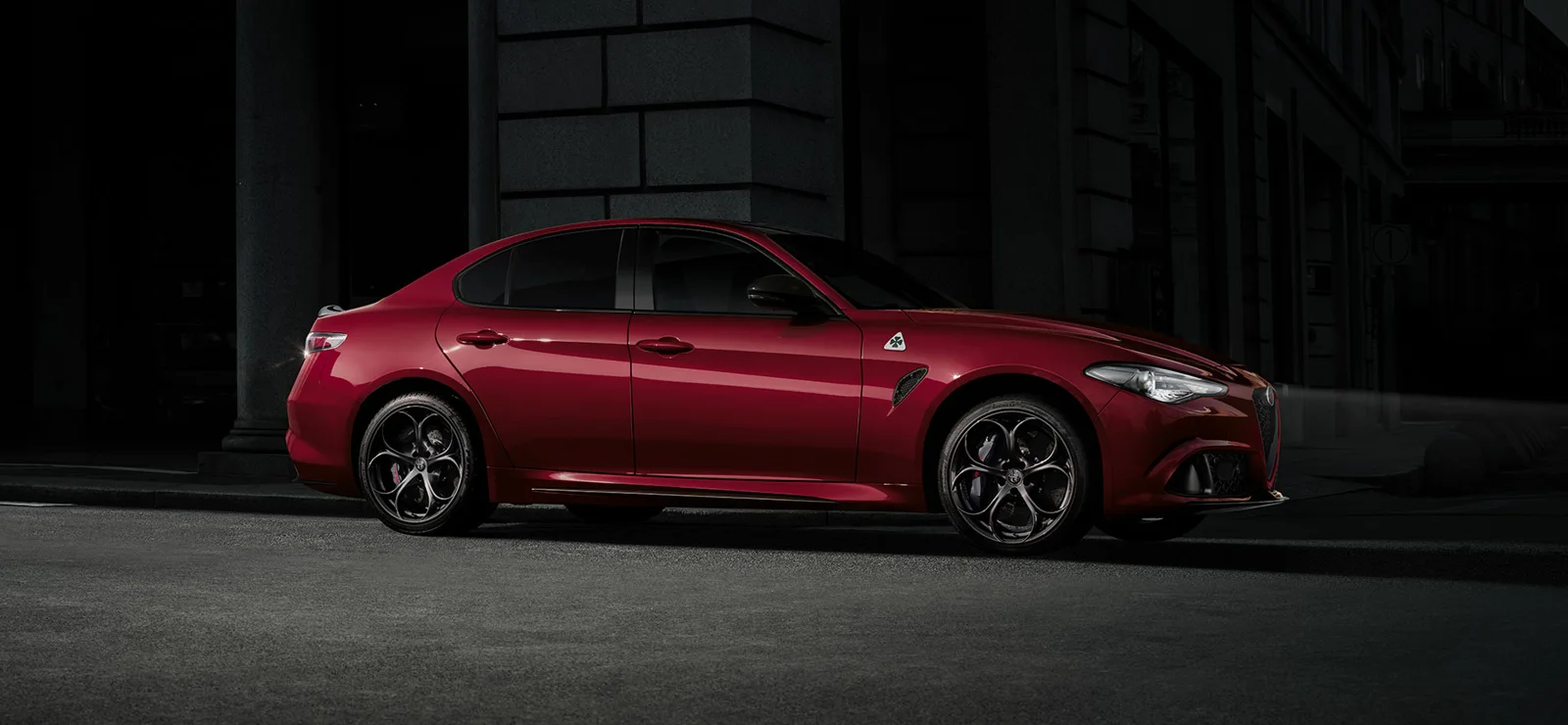 Alfa Romeo Giulia Quadrifoglio at night, headlights on