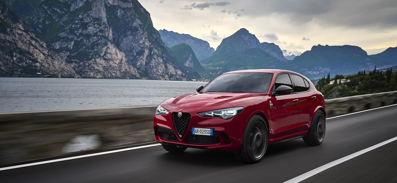 Alfa Romeo Stelvio Quadrifoglio in motion on a lakeside mountain road