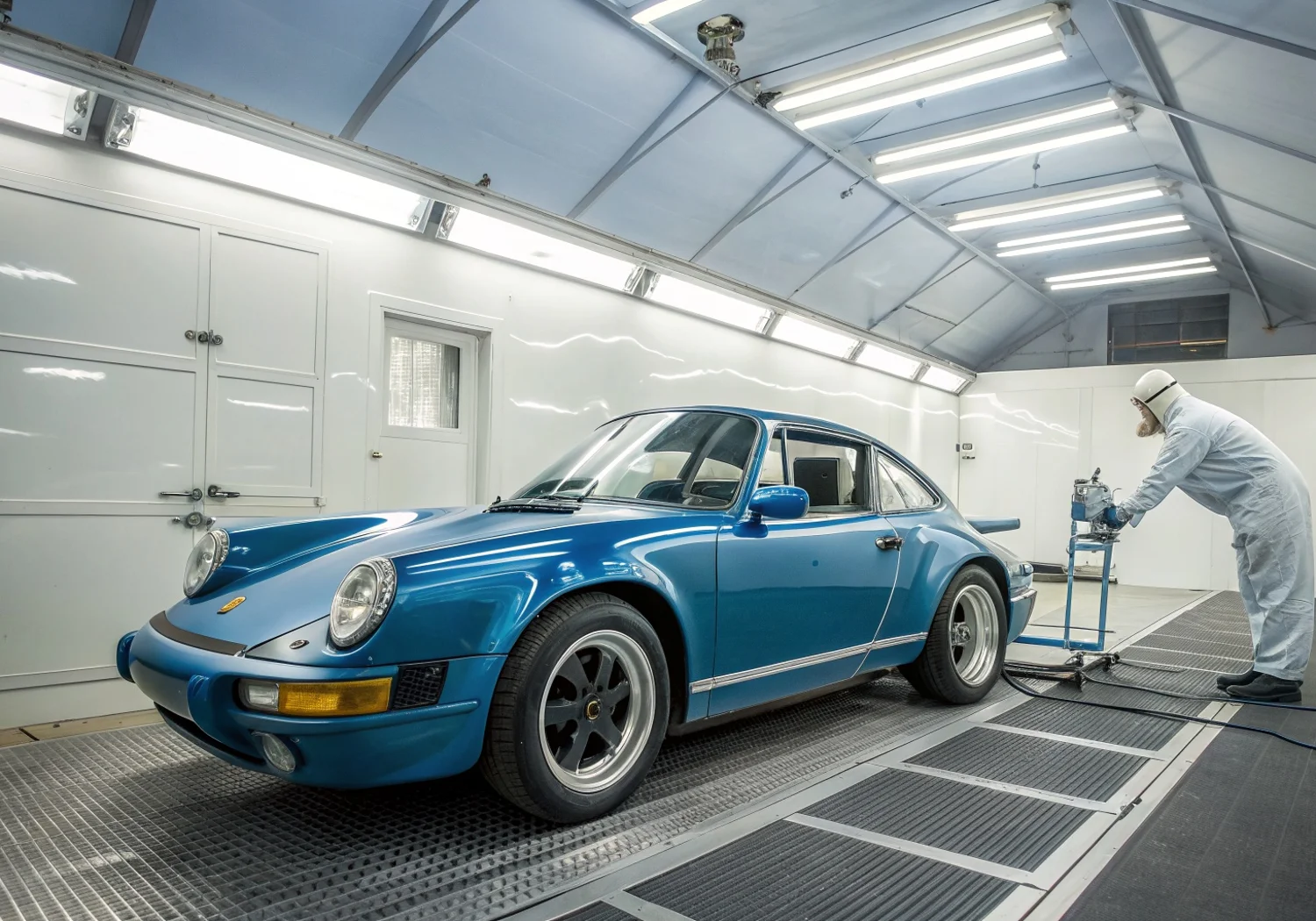 Porsche 911 in the paint booth — luxury body repair and paint matching in Miami