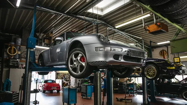 Porsche 911 on a lift during a Gold pre-purchase inspection at Alfa Garage Miami, $480