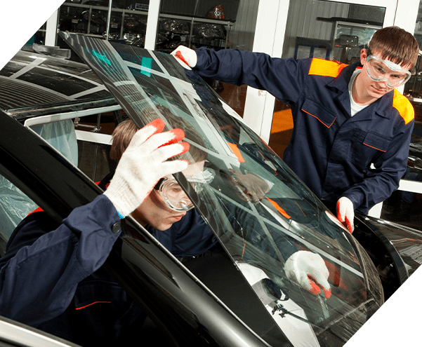 Two Real Mechanics doing auto glass service in an Auto Repair Shop