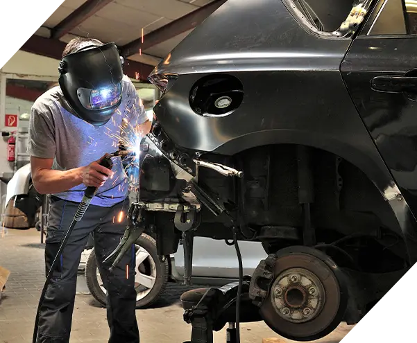 Car body worker welding car body.